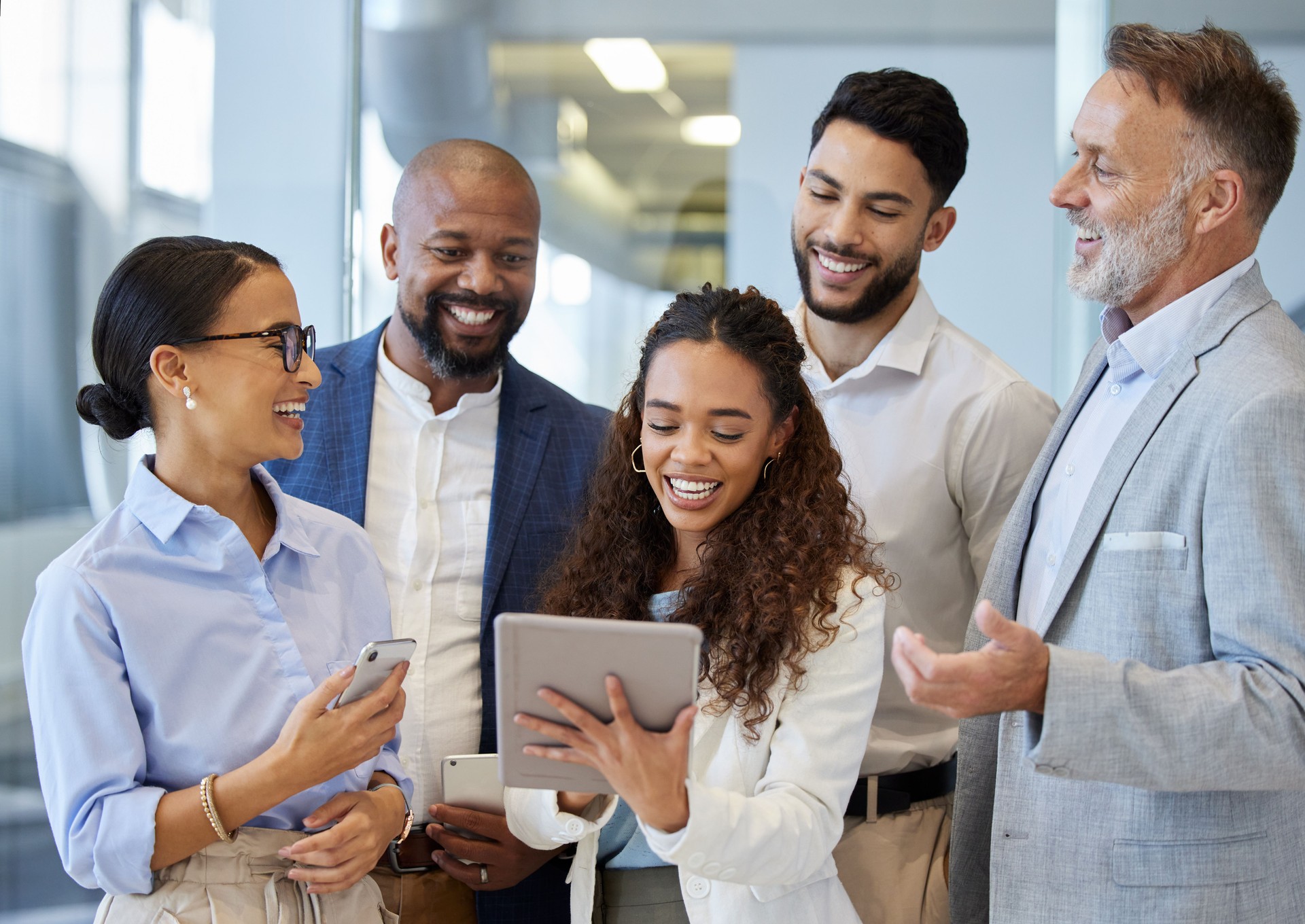 Shot of a group of businesspeople working together on a digital tablet in an office
